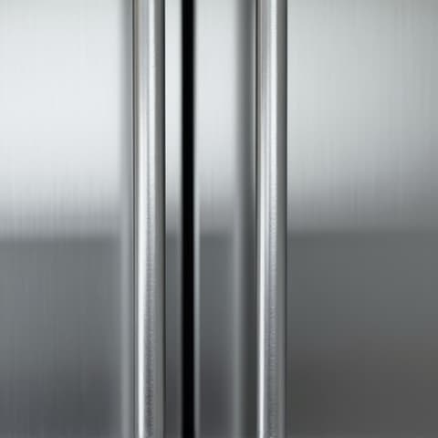 Technician adjusting a gas burner on a Wolf cooktop in an elegant Elk Grove kitchen, ensuring perfect flame control for gourmet cooking.